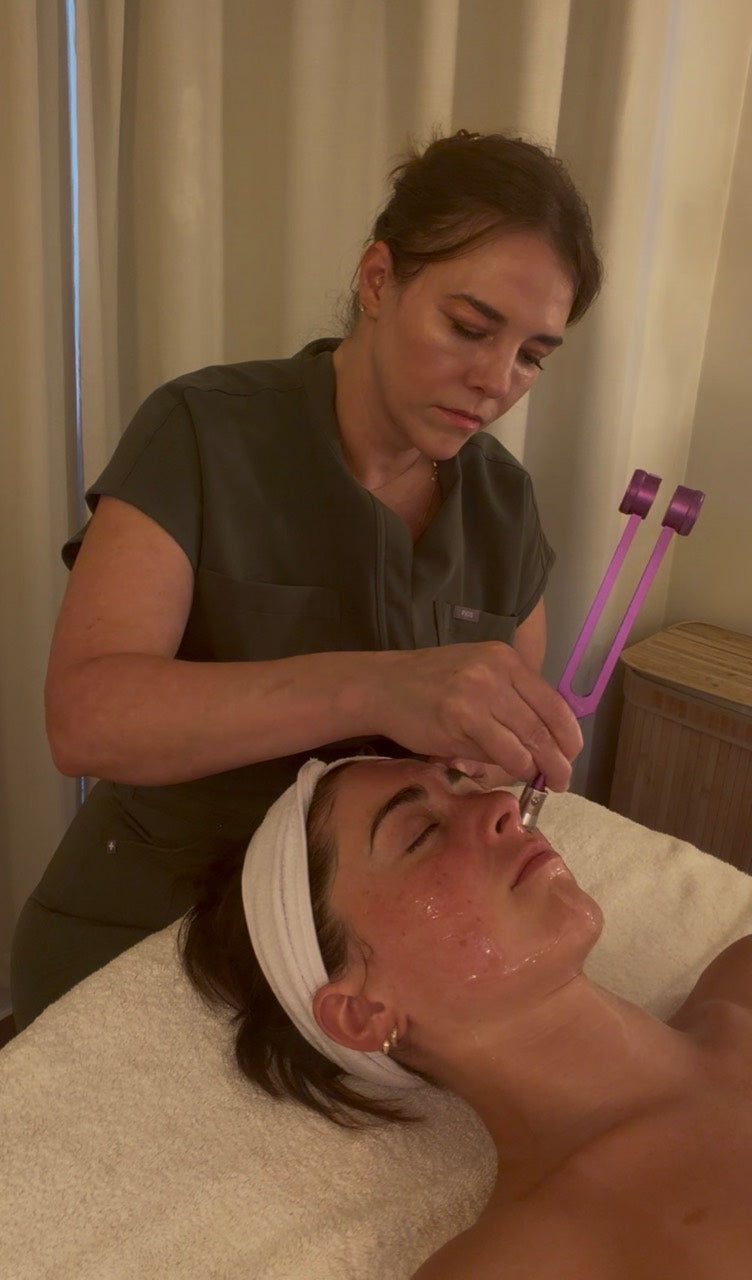 Weighted tuning fork skincare treatment during the Frequency Facial